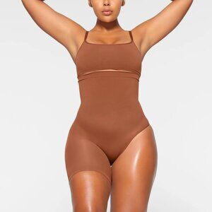 SKIMS Seamless Sculpt Solution Short Left Leg Exposed Shapewear in Bronze (S)